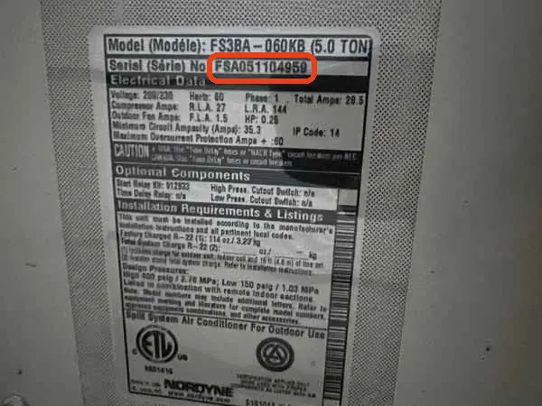 Data plate on a Frigidaire air conditioner, serial number FSA051104959 outlined in red