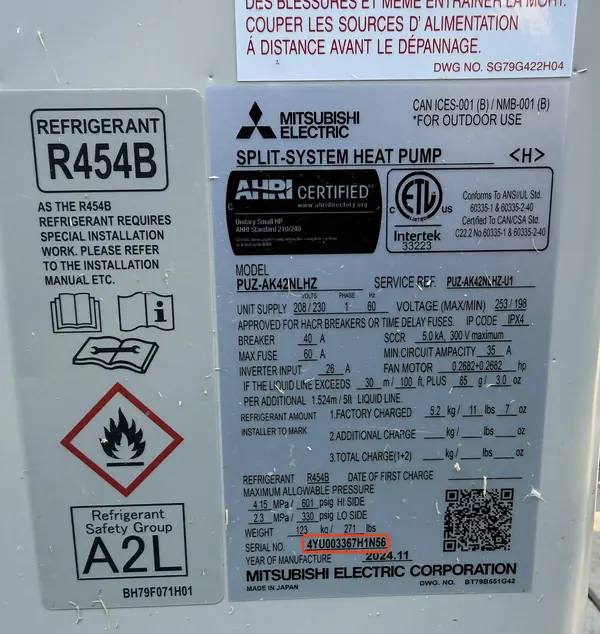 Data plate on a Mitsubishi Electric heat pump, serial number 4YU003367 outlined in red