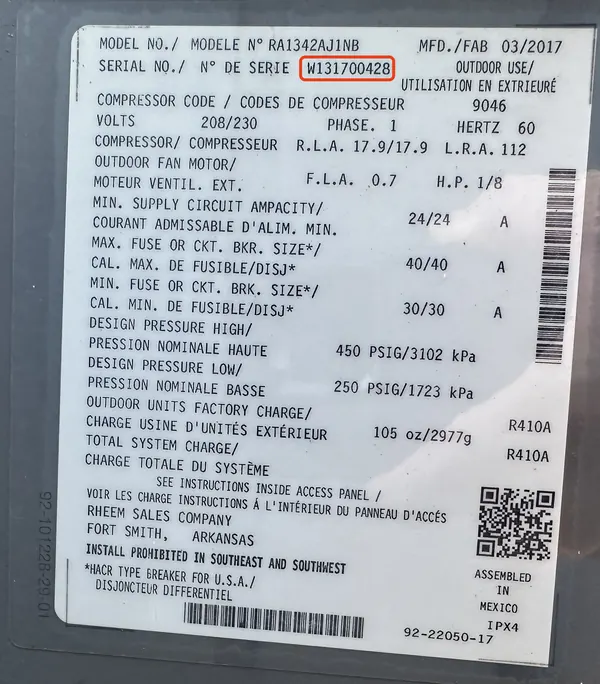 Data plate on a Rheem air conditioner, serial number W131700428 outlined in red