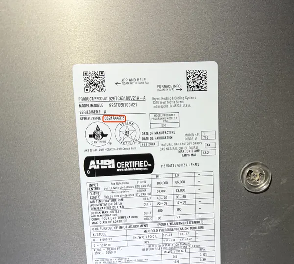 Data plate on the front panel of a Bryant gas furnace, serial number outlined in red