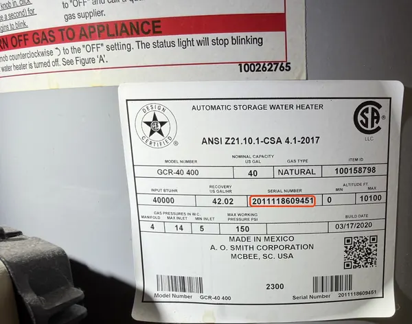 Rating plate on an A.O. Smith gas water heater, serial number 2011118609451 outlined in red